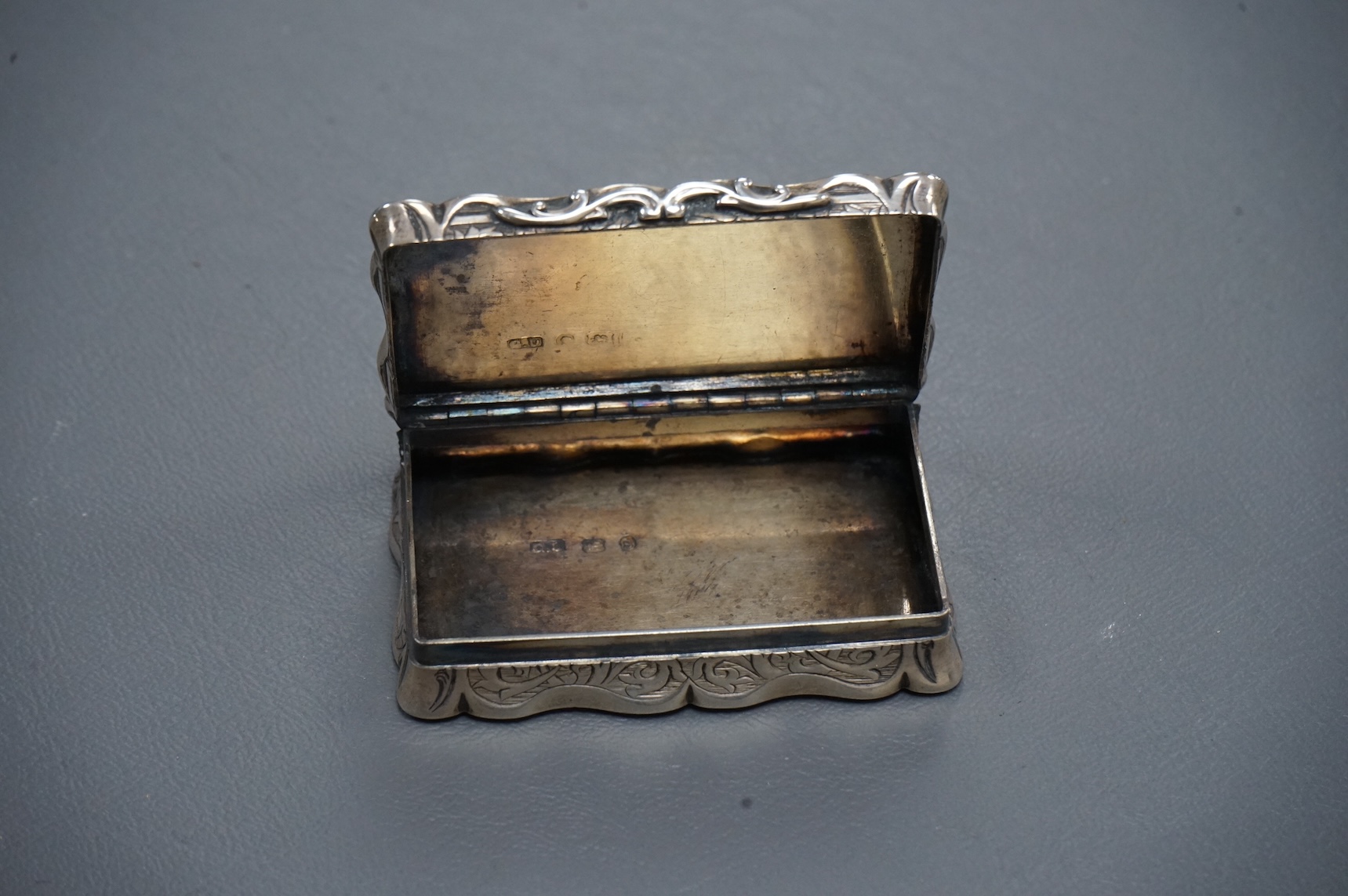 A Victorian engraved silver shaped rectangular snuff box, by George Unite, Birmingham, 1867, 7cm.